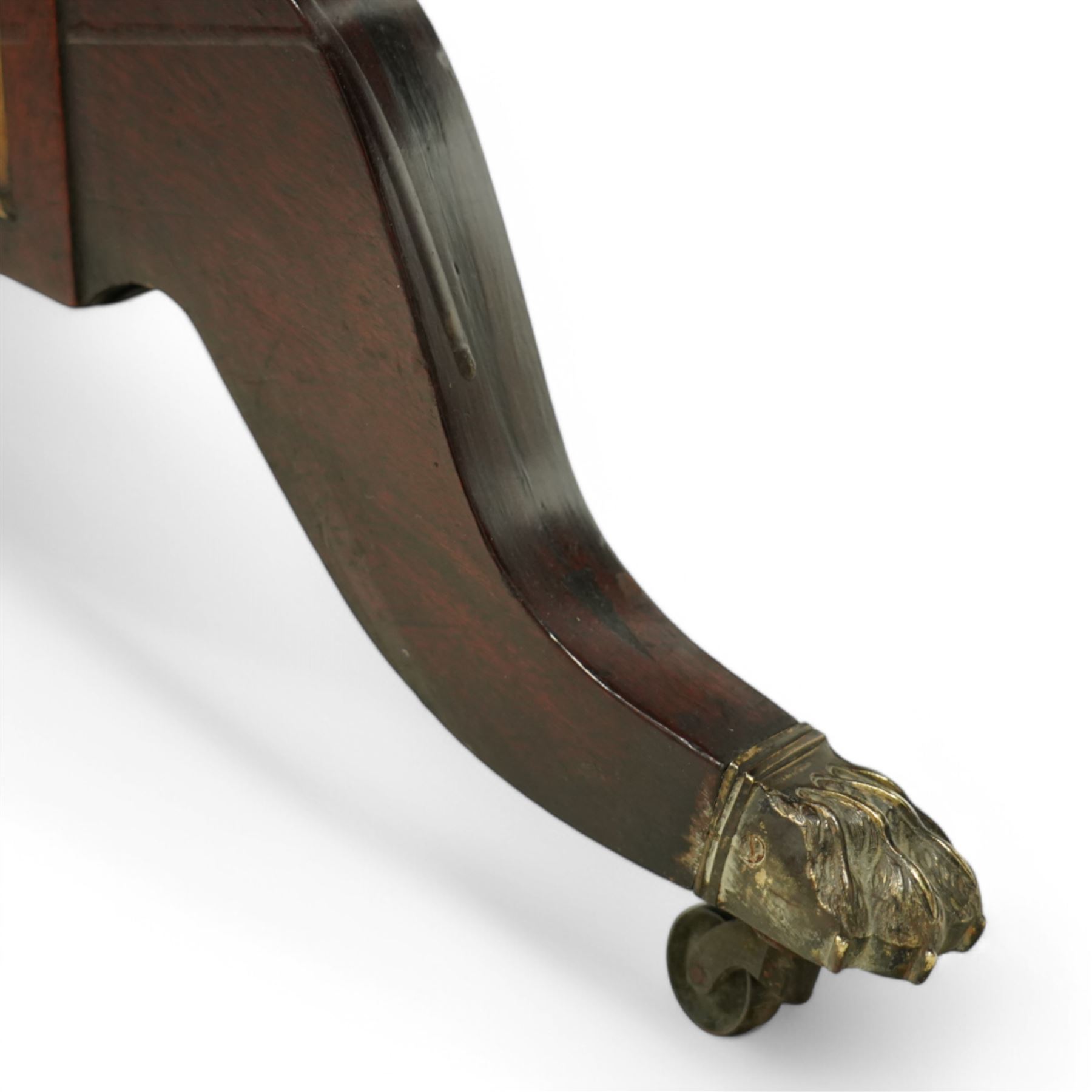 Regency mahogany and ebony inlaid fold-over tea table with reeded edge above spiral reeded centre stretcher on lyre supports with brass star inlaid panel on out swept legs with lion paw brass castors 