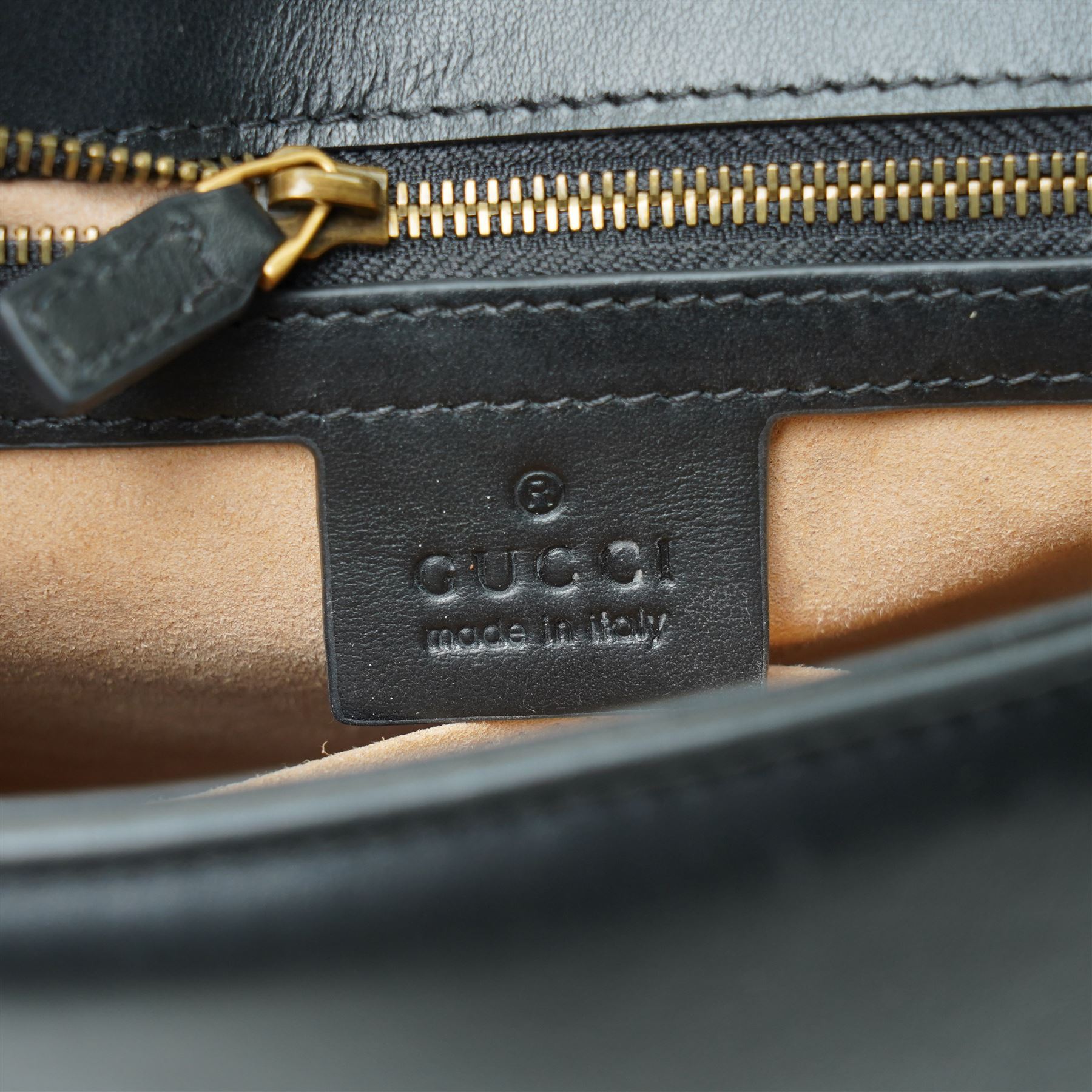 Gucci GG Marmont black matelassé leather top handle bag, made in Italy, with chevron quilted leather and heart motif to the reverse, antique gold-tone Double G front hardware, leather top handle and detachable chain shoulder strap with leather shoulder guard, front flap closure, suede-effect interior with zip pocket and leather logo tab stamped Gucci made in Italy, together with original Gucci dust bag and carrier, W27cm D11cm H20cm