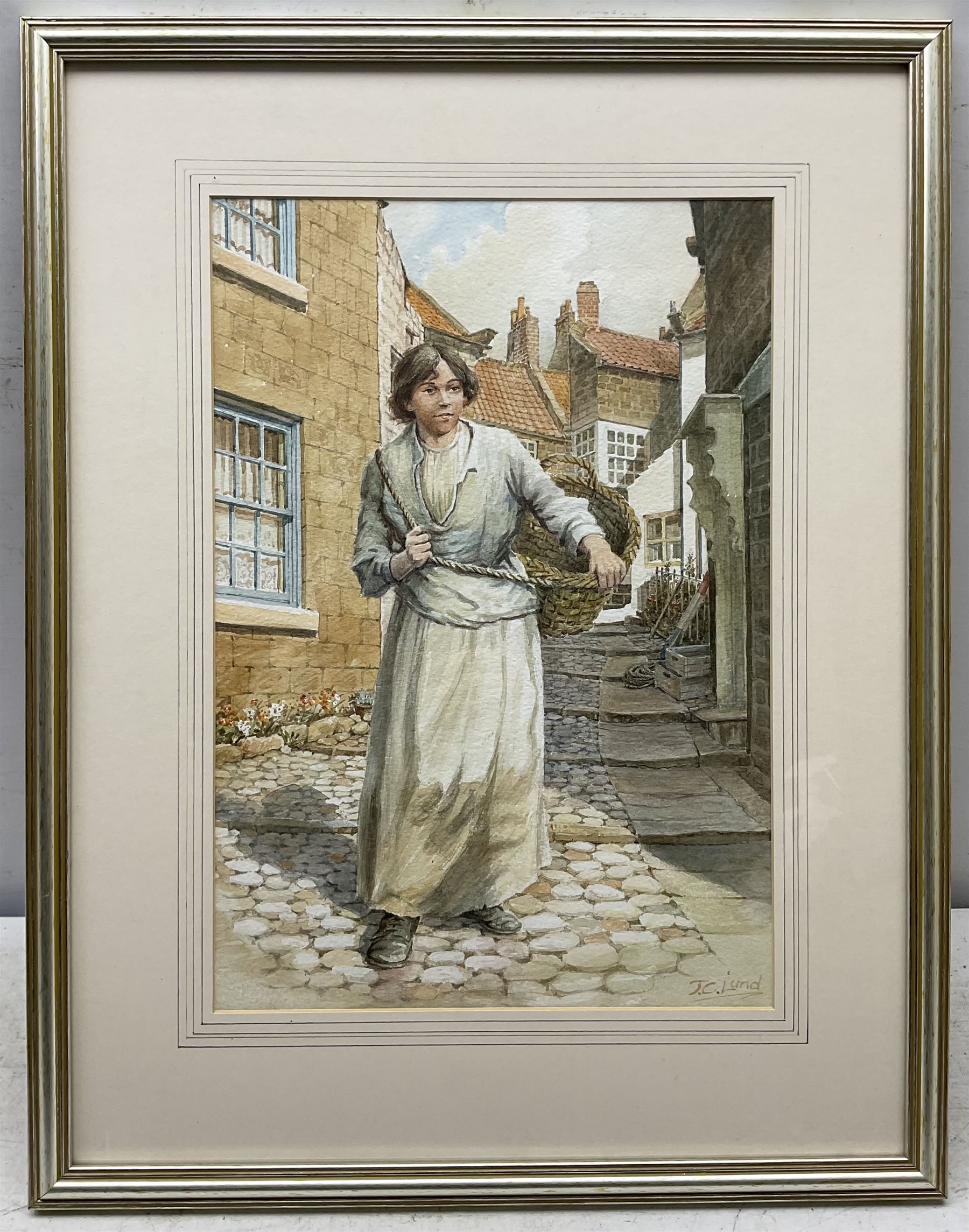 John Cecil Lund (British 1932-): Fishergirl at Robin Hood's Bay, watercolour signed 38cm x 26cm