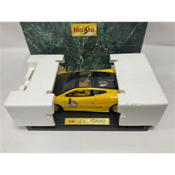 Two Maisto 1:12 scale Jaguar XJ220 ‘Racing’ cars in yellow, both on plinths in original boxes 