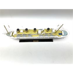 Wooden model of RMS Titanic, on a fixed black stand bearing plaque inscribed 'Titanic 1912', L54cm, H22cm, together with model of a sloop, gaff rigged on stand bearing plaque inscribed 'Sloop' L32cm, H42cm; and model of a fishing trawler on a stand bearing plaque inscribed 'Chalutier' L35cm, H28cm (3)