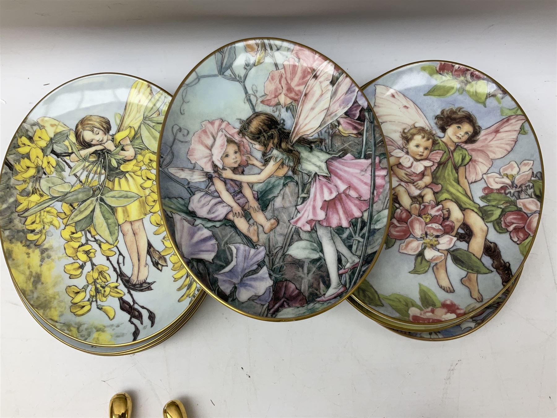 Royal Worcester Flower Fairies oval collectors plates, Goebel mustard pot, two Danbury Mint Fairy Tale bells, and pair of Hutschenreuther candlesticks decorated with scenes of Puss in Boots
