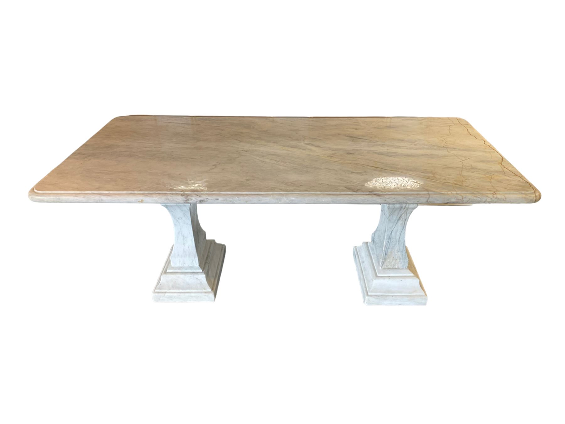 Classical Grecian design Carrera marble centre table, the rectangular single slab top with rounded corners and carved edge, raised on twin pedestals comprised of three pieces with a waisted column on a stepped plinth