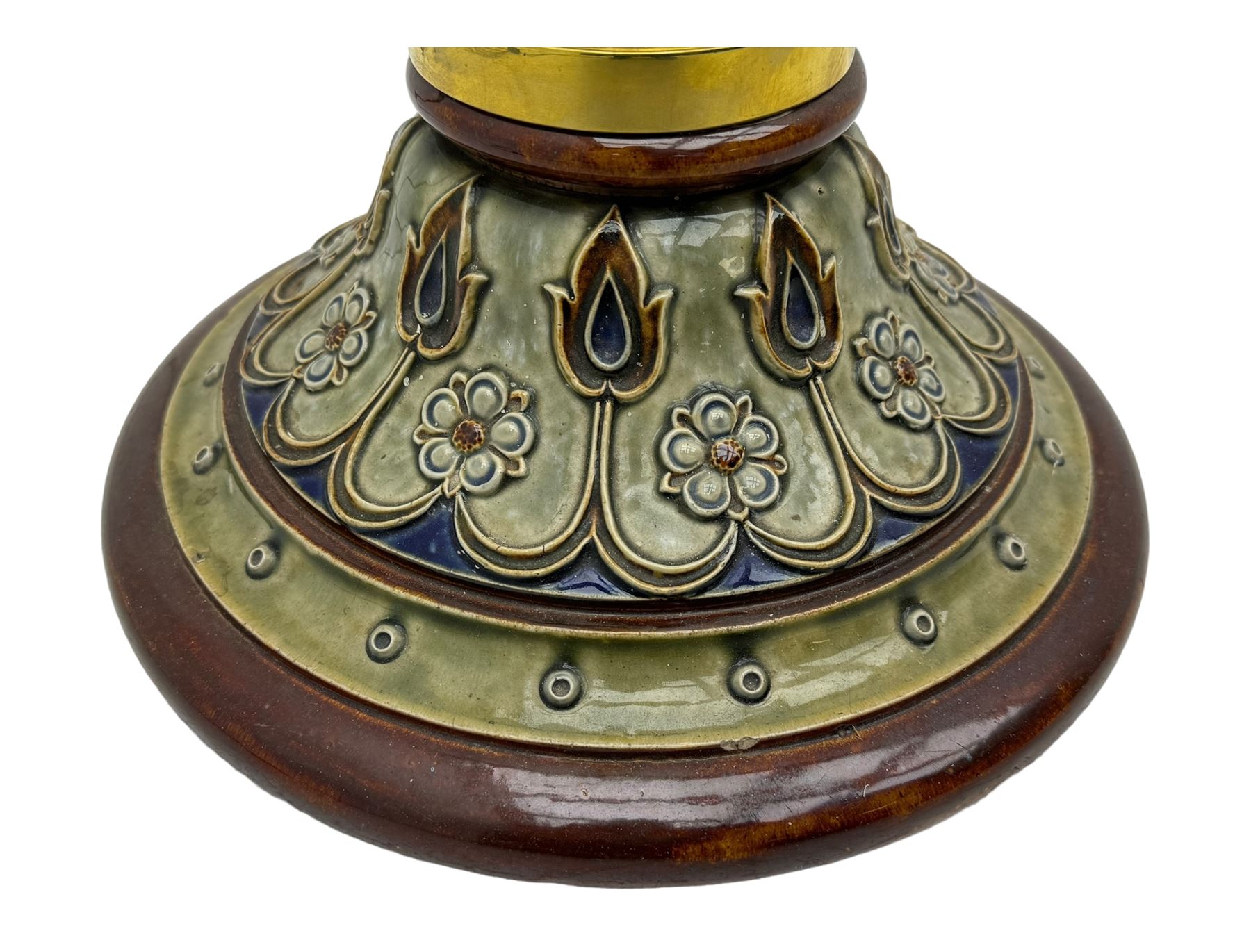 Early 20th century brass adjustable floor lamp, Royal Doulton decorative ceramic base embellished with raised floral and scroll patterns, stamped, brass column and adjustable arms terminating in brass bulb holder