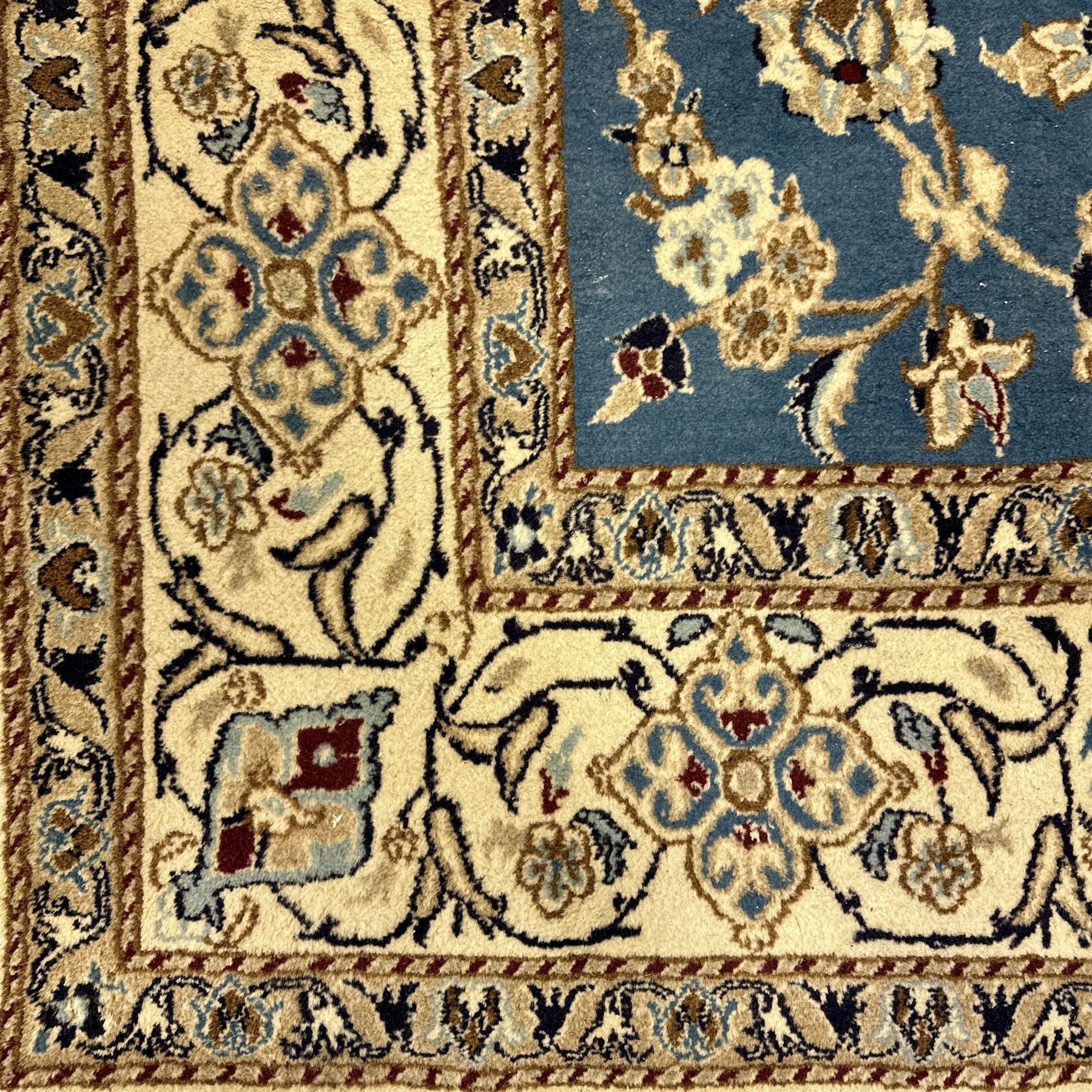Central Persian Kashan rug, densely knotted, in a teal and cream ground, central medallion with circular rosette surrounded by a highly detailed field of radiating palmettes, vine arabesque patterns, rosettes, and  lotus blossoms, main border with alternating palmettes flanked by two narrower guard borders with a repeating floral meander design 