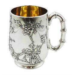 Late 19th/early 20th century Chinese export silver mug, by Wang Hing of Hong Kong, of slightly bellied form upon a circular foot, with bamboo modelled handle and applied and chased decoration of prunus blossom, impressed beneath with initials WH, 90 and character mark, H12.5cm, approximate weight 16.01 ozt (498 grams)