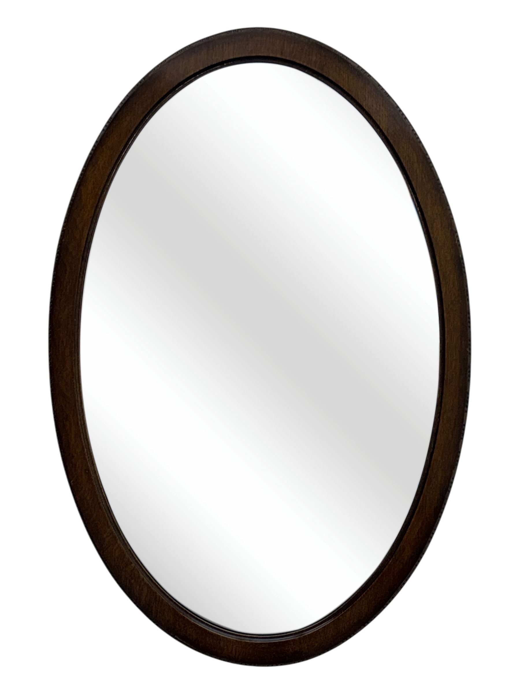 Late 19th century black-painted cane seat chair; early 20th century radial spindle-back chair with green upholstery; early 20th century mahogany single-drawer side table; mid-20th century carved wooden stool with harp motif; early 20th century hexagonal bamboo stand; two oval mirrors (7)