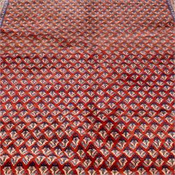 West Persian Saraband (Boteh-Mir) runner madder-red field densely decorated with repeating boteh motifs, arranged in diagonal rows enclosed by a geometric border of stylized motifs, between multiple guard stripes, cotton fringe ends  