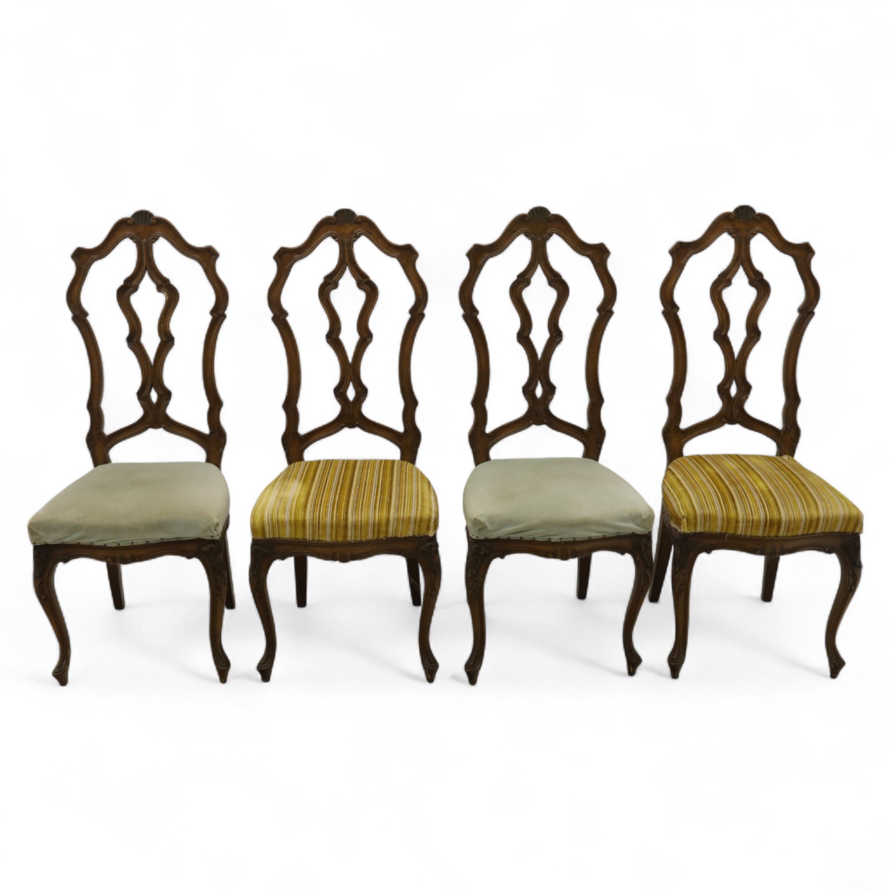 20th-century set of four French provincial-style stained beech dining chairs, pierced cartouche back with fan carving, with a scroll moulded frame above a padded serpentine seat on cabriole legs 
