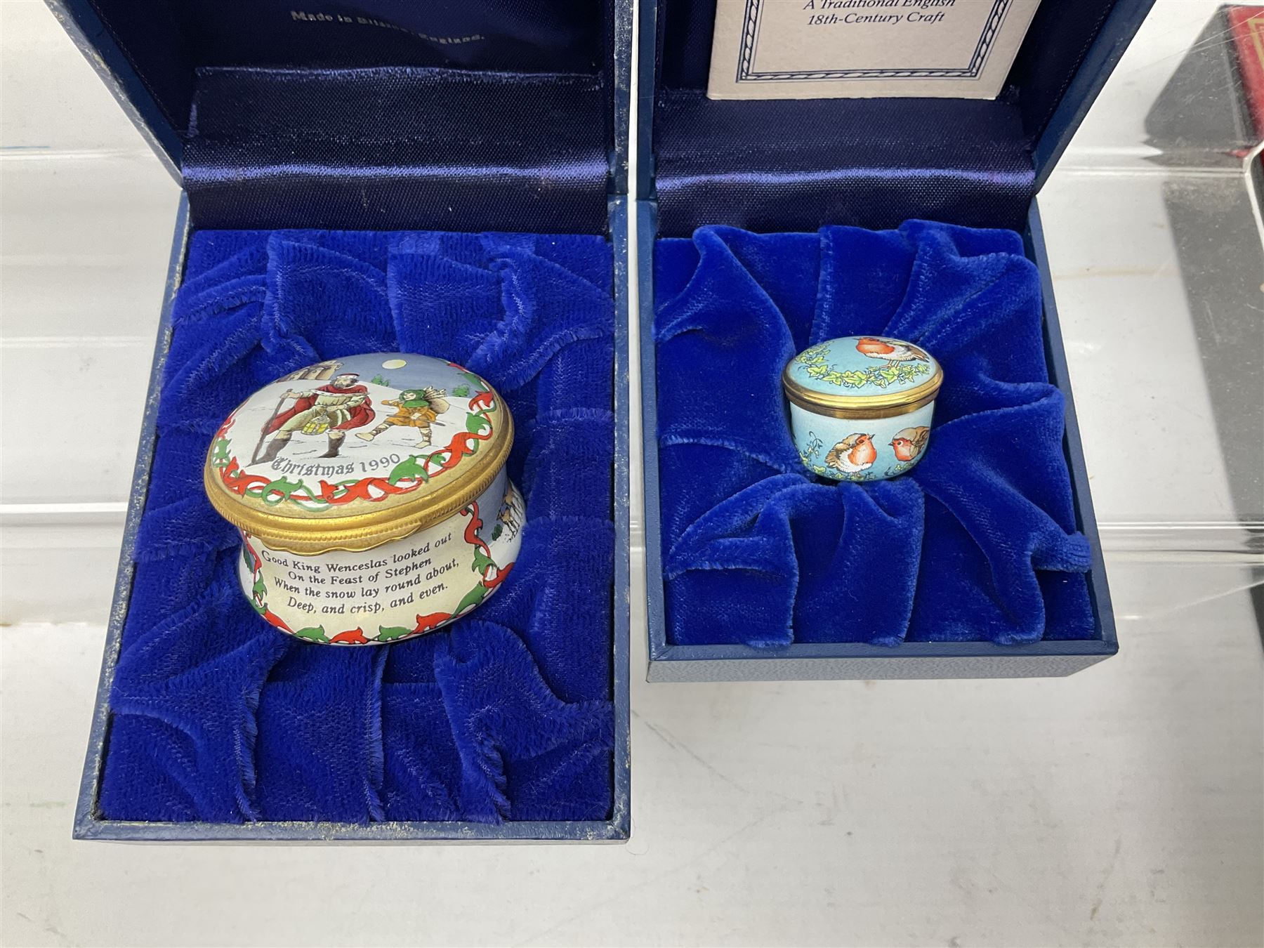 Eight Christmas themed Halcyon Days enamel boxes, and a Halcyon Days enamel bonbonniere modelled as a snowman, each in fitted box 