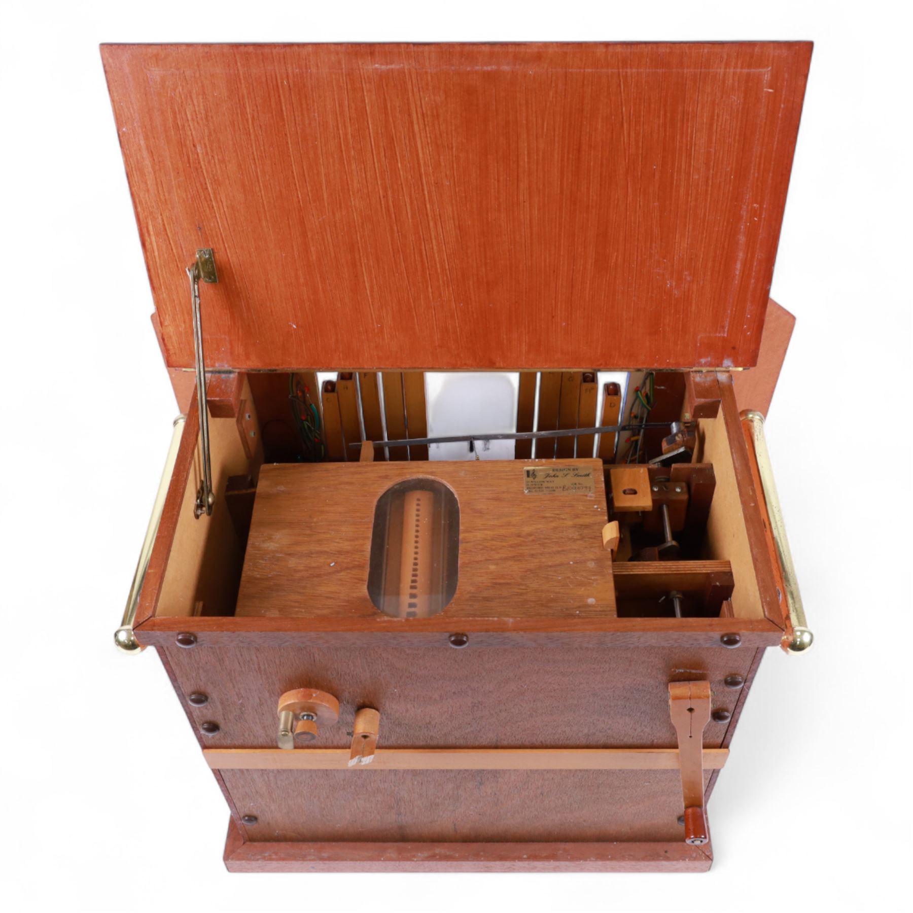 John Smith-20th century hand cranked portable street organ “music and mirth” in a wooden case with carrying handles, with speaking pipes and mannequin to the front. All pipes present, however the mechanism is in need of restoration. With five paper music rolls.