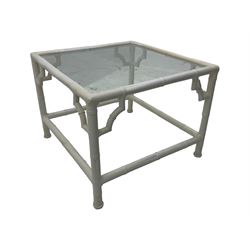 Late 20th century faux bamboo conservatory sofa, white painted frame with geometric openwork back and sides, loose cream cushions, on cylindrical supports (W134cm, D76cm, H80cm); matching armchair (W75cm, D76cm, H80cm); matching coffee table with glass insert (W46cm, D45cm, H36cm)