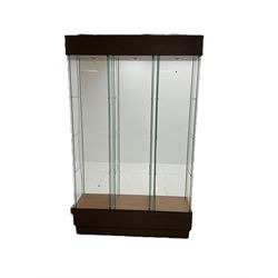 Light oak and glass triple display cabinet, glazed back and sides with three divisions, each with single glazed door enclosing three shelves, light fitting to top of each section