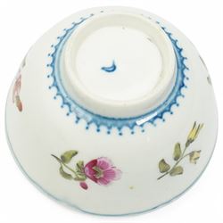 Worcester tea bowl and saucer, c.1770, painted with polychromatic floral sprays within blue borders, bearing crescent marks to base, with another similar early example, unmarked
