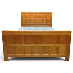 Mouseman - 4'6 panelled oak double bedstead, the head and footboard panelled with arcade carved cresting rails, with bed base and Vono metal rails, with carved mouse signature, by the workshop of Robert Thompson of Kilburn