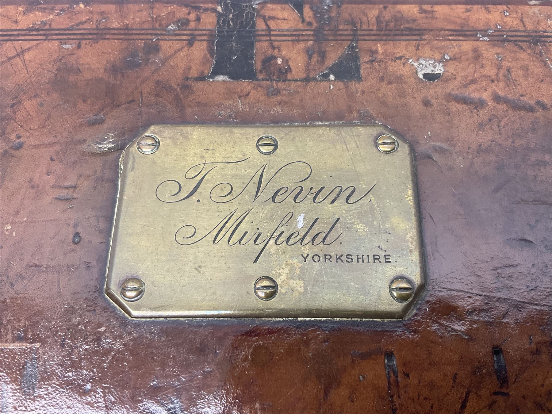 Leather shotgun case, the red baize lined interior with the trade labels of Westley Richards & Co., London, a brass plaque inscribed 'T Nevin, Mirfield, Yorkshire' to cover, with key, case to fit barrel 76cm (30 inches)  
