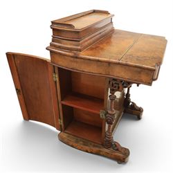 Victorian burr walnut Davenport, with hinged stationary top and slope, pull out writing surface with tooled green leather inset top, carved and turned front supports, flanked by two cupboard doors, raised on castors 