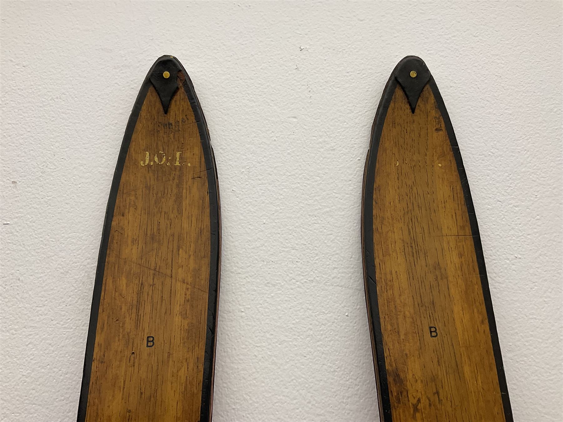 Pair of 1930s wooden skis, with painted metal runners beneath stamped Attenhofer, with retailers label for Ernst Gertsch Central Sports, L206cm