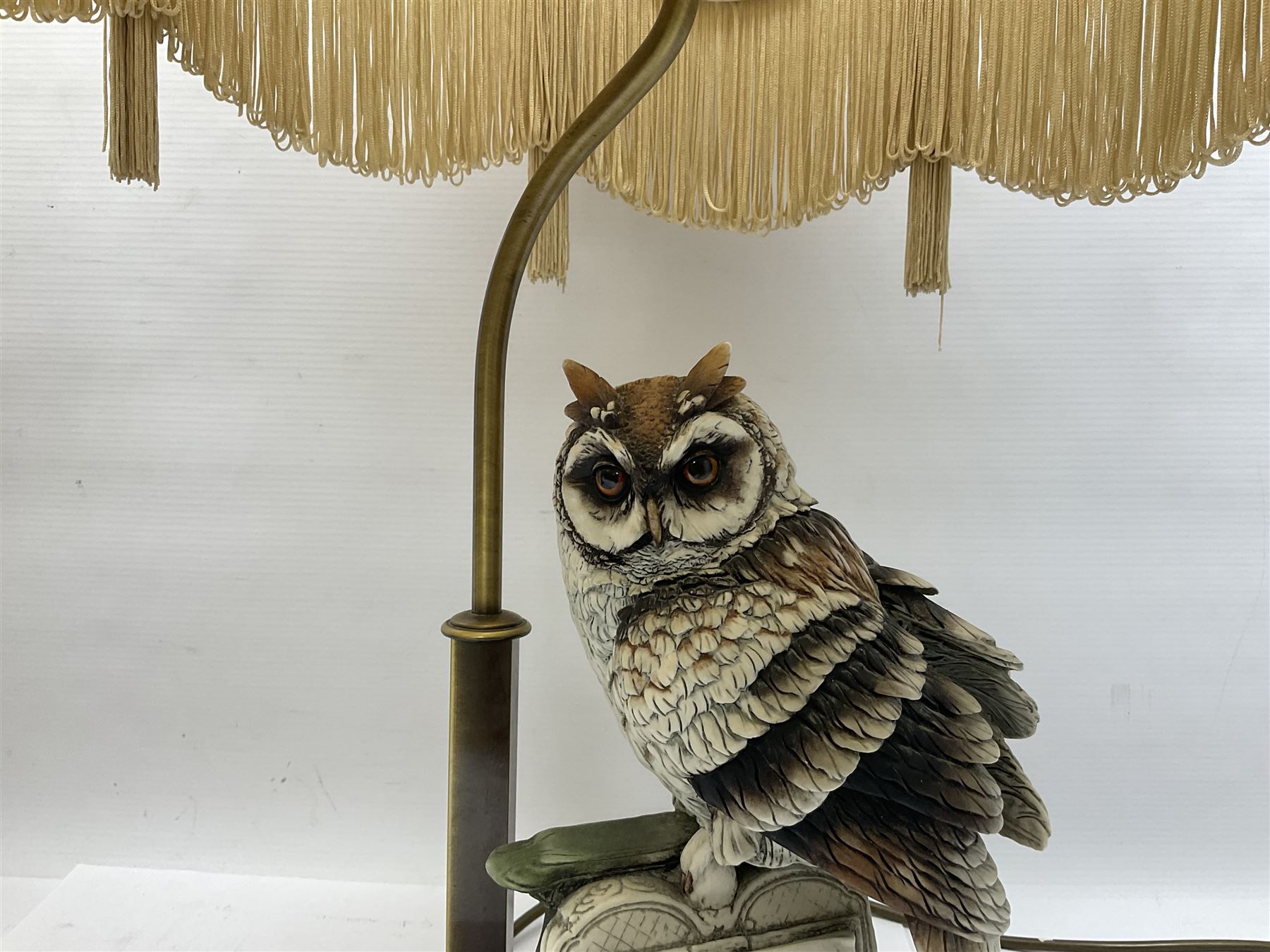 Two Giuseppe Armani figural lamps, the first modelled as an owl perched upon a book, the second modelled as a pair of owls perched upon blackberry branch, each with damask fabric tassel shades, tallest H76cm
