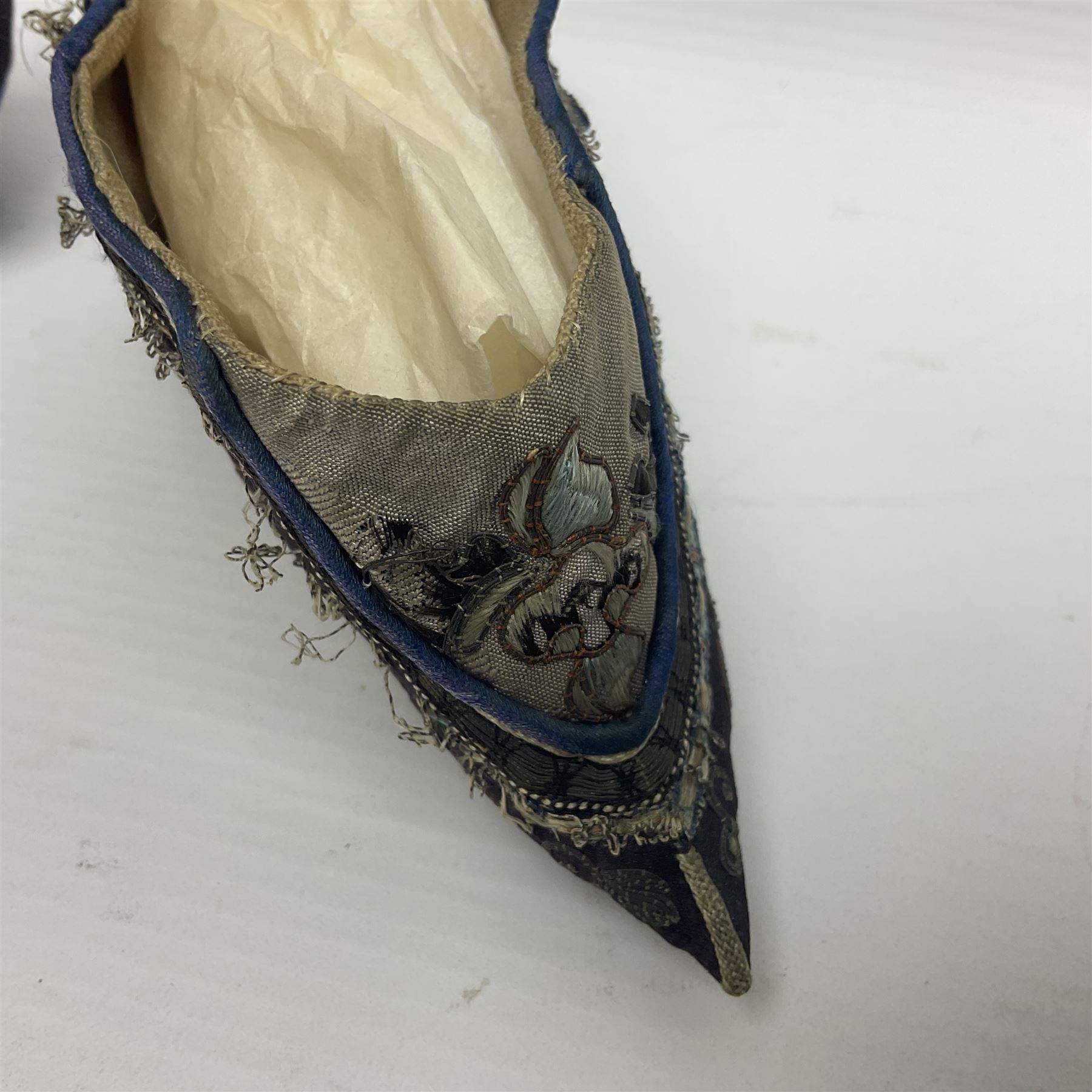 Pair of Chinese silk embroidered lotus shoes, for bound feet, a blue ground with floral detailing L15cm