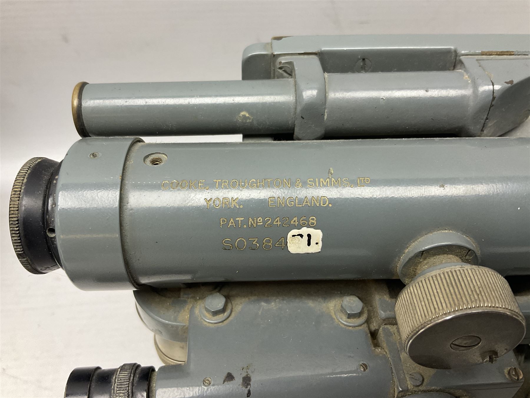 Cooke Troughton & Simms grey painted brass dumpy level in carrying case; and WW2 British .303 Vickers Machine Gun brass Clinometer, stamped 'V.E. 0067' serial No. 2370,  dated 1944 unboxed (2)