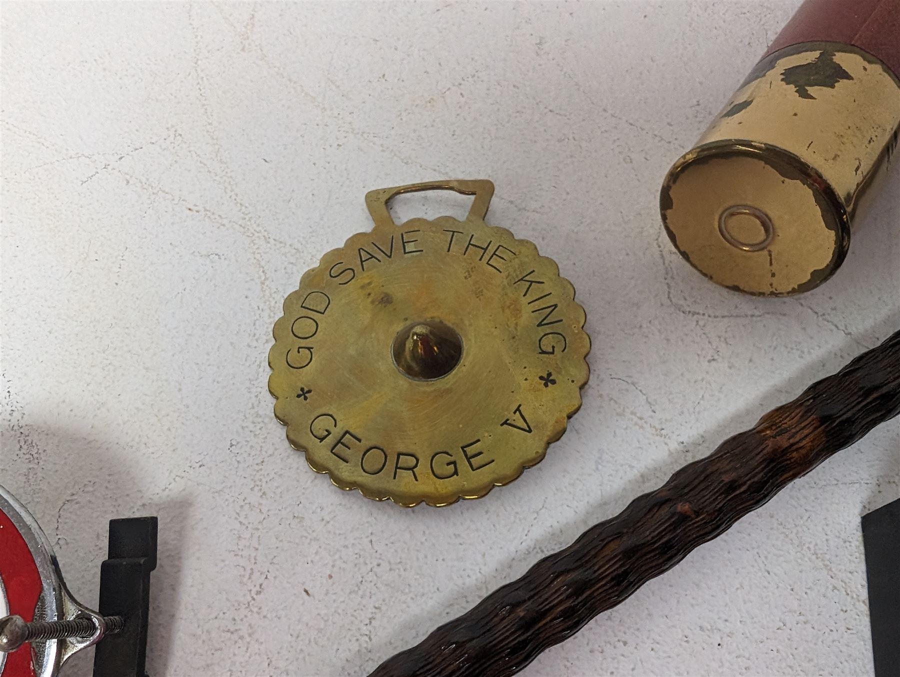 Walking stick with carved monkey handle, glass shooting flask in the form of a cartridge, bullet casings and other collectables