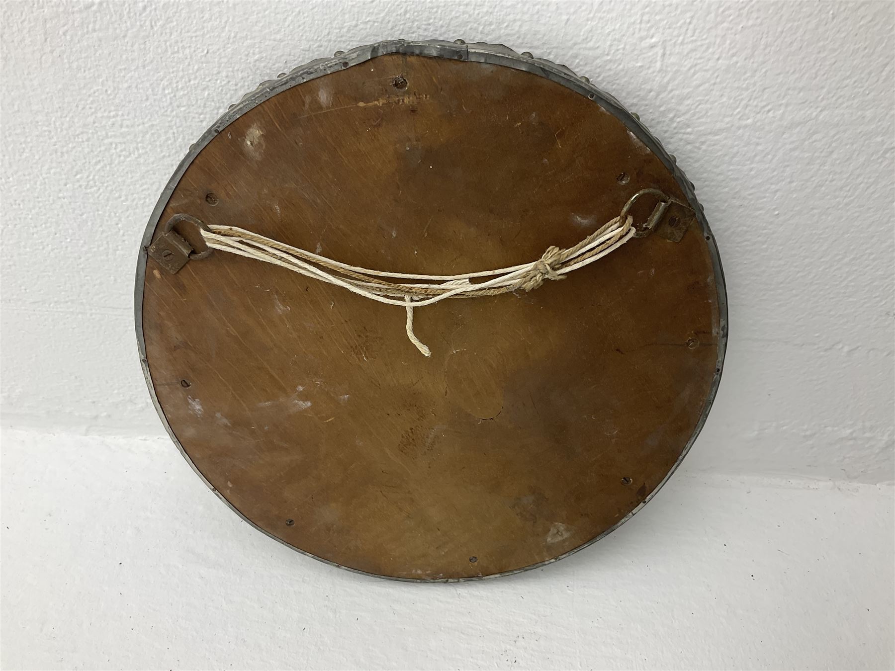 Arts & Crafts style circular hammered pewter mirror inset with four turquoise cabochons, D27.5cm