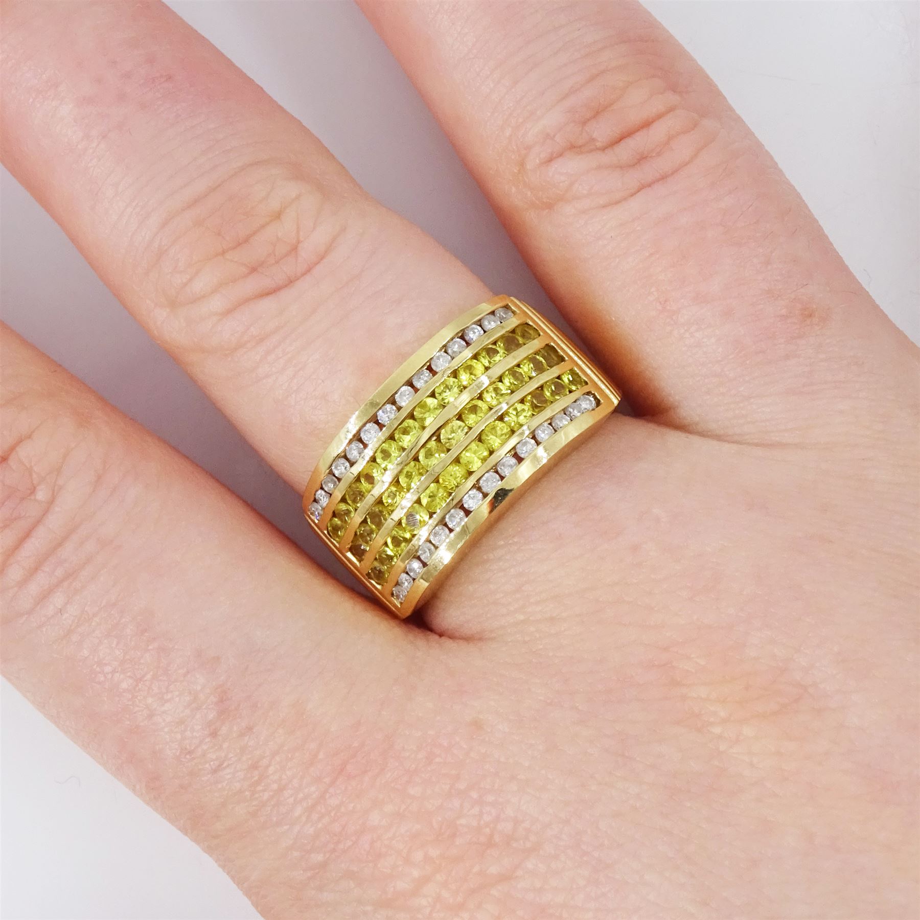 14ct sapphire and diamond half eternity ring, channel set with two rows of round brilliant cut diamonds, spaced by three rows of round cut yellow sapphires, hallmarked, total sapphire weight approx 1.45 carat, total diamond weight approx 0.30 carat