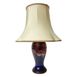 Moorcroft table lamp, of inverted baluster form, decorated in the Anemone pattern, on wooden plinth, with accompanying cream shade of lobed form, with piped detail, H36cm (excluding fitting)