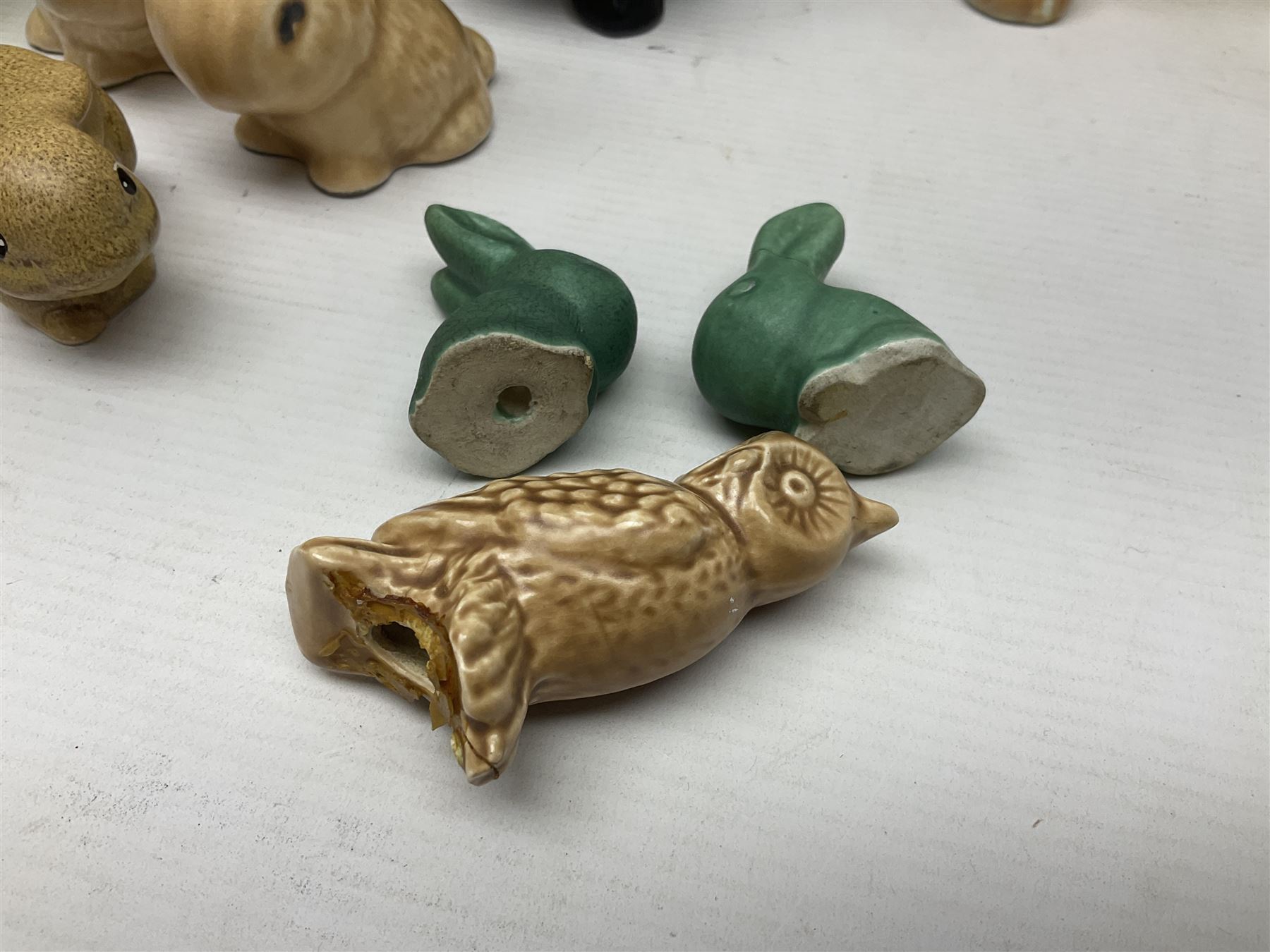 Collection of Sylvac and similar animal figures, including rabbits, hares and dogs, together with Falcon budgie vase, etc 