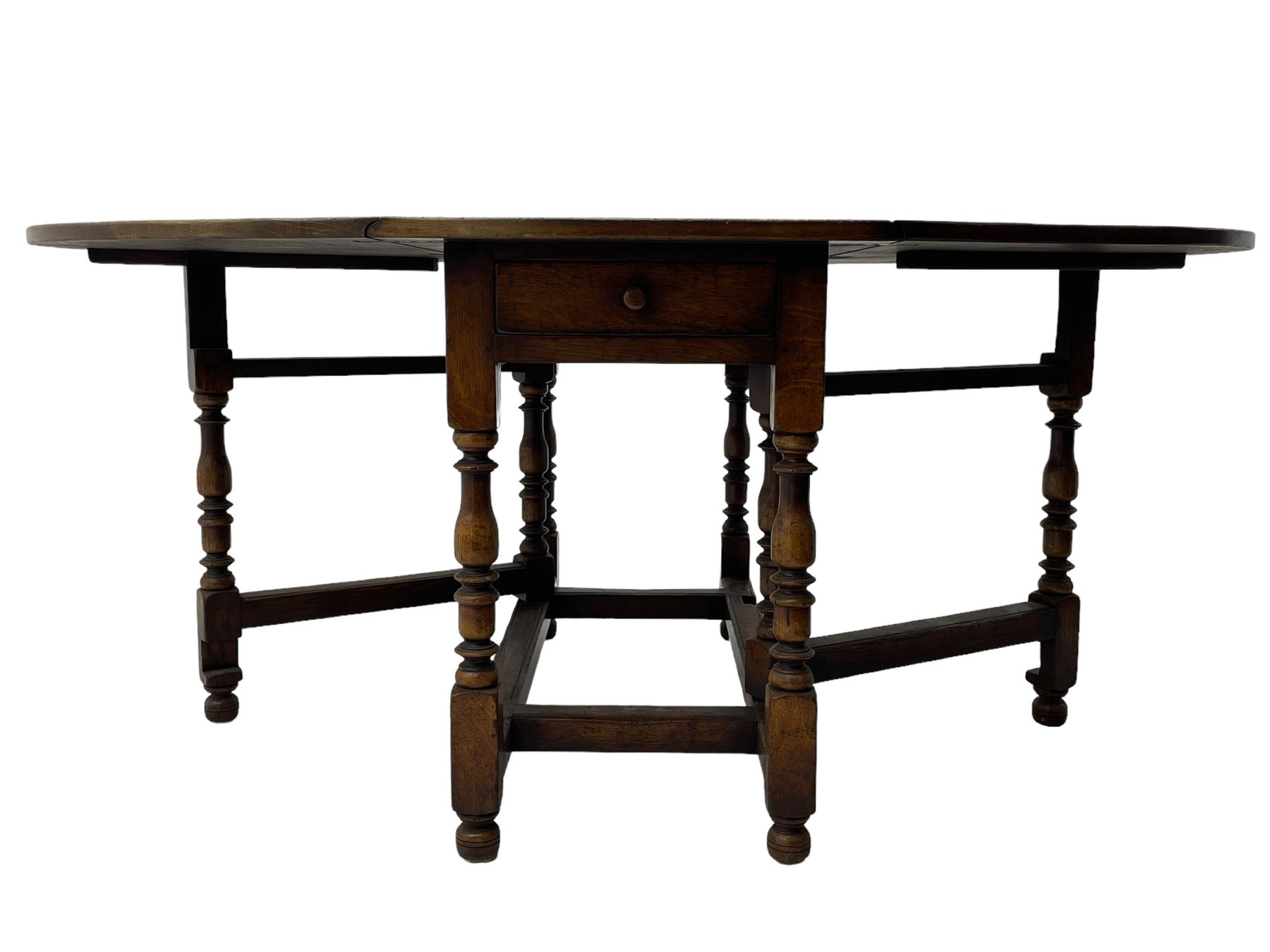 19th century oak dining table, oval drop-leaf top on gate-leg action base, turned supports united by turned stretchers, fitted with single end drawer