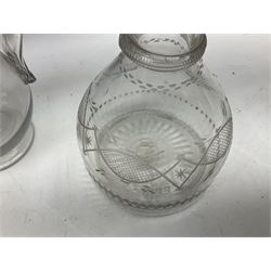 19th century clear glass jug with double ring neck and swan neck handle, together with four 19th century clear glass decanters to include etched examples with triple ring necks, cut examples etc