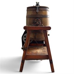 Two early 20th century dairy equipment items: Waide & Sons, Leeds – oak barrel butter churn with iron bands, later converted to electric operation, on trestle stand (W71cm H115cm); Lister – ‘Ball Bearing’ cast iron cream separator, with hopper and foot pedal, in red-painted finish (W47cm H49cm)