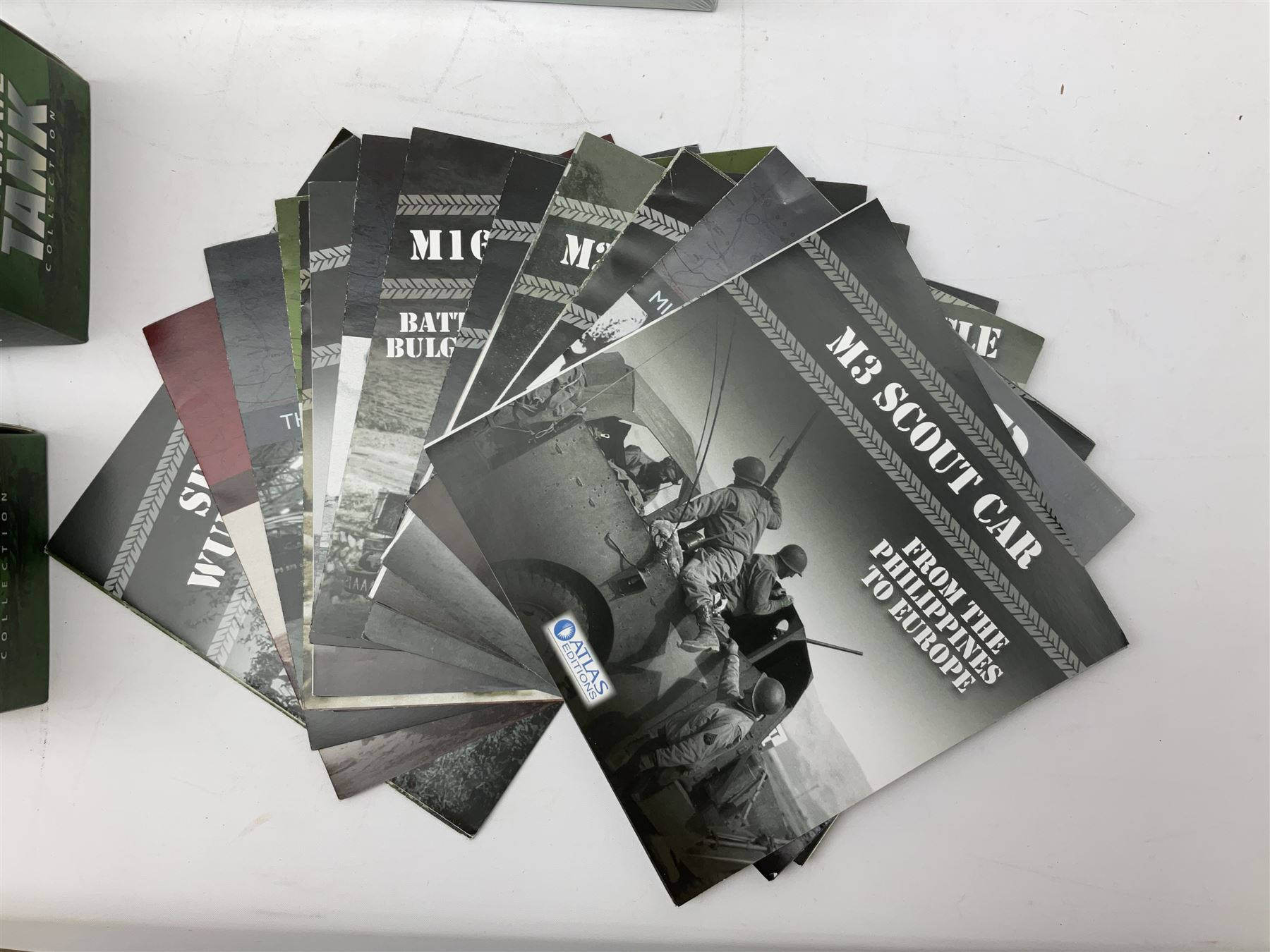 Sixteen Atlas Editions die-cast models of military vehicles including six Ultimate Tank Collection; all in perspex display cases; fourteen boxed; with associated paperwork (16)