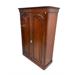 19th century mahogany double wardrobe, foliate carved projecting cornice over banded frieze, two panelled doors with applied carved cartouche moulding enclosing hanging rail with drawer to base, the right fitted with hanging rail over two sliding trays and three drawers