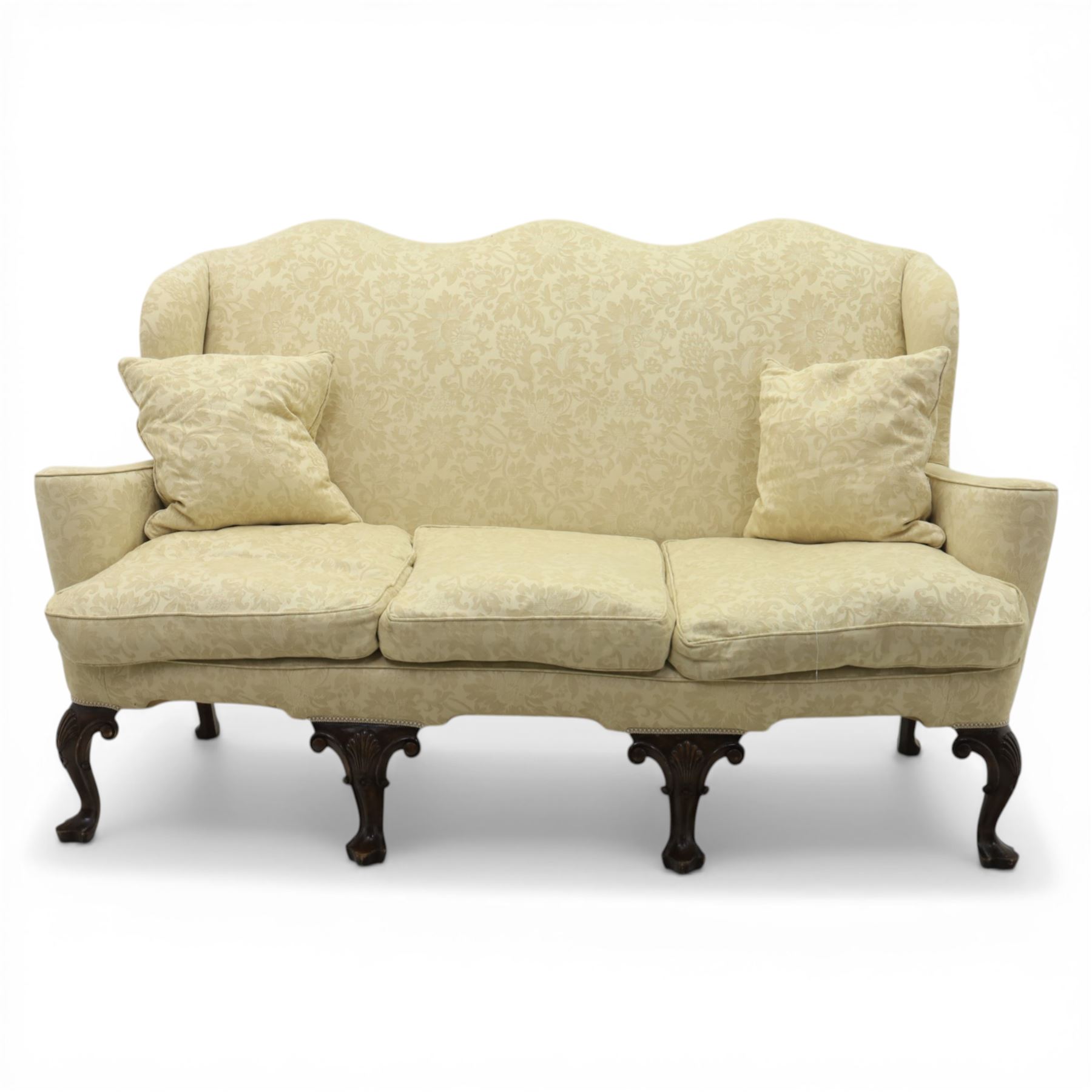 19th century Queen Anne style cream foliate upholstered three seat settee, the shaped and waisted back with serpentine cresting, padded arms over loose seat cushions, raised upon carved cabriole supports with shell carved knees