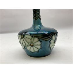 Minton Secessionist vase, with tube-lined stylised flower decoration, upon a blue ground, with printed mark to base 'Minton Ltd, No. 32', H13cm
