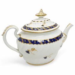 18th century Worcester teapot and stand of oval wrythen form decorated with flowers and leaves in blue and gilt, with blue crescent mark