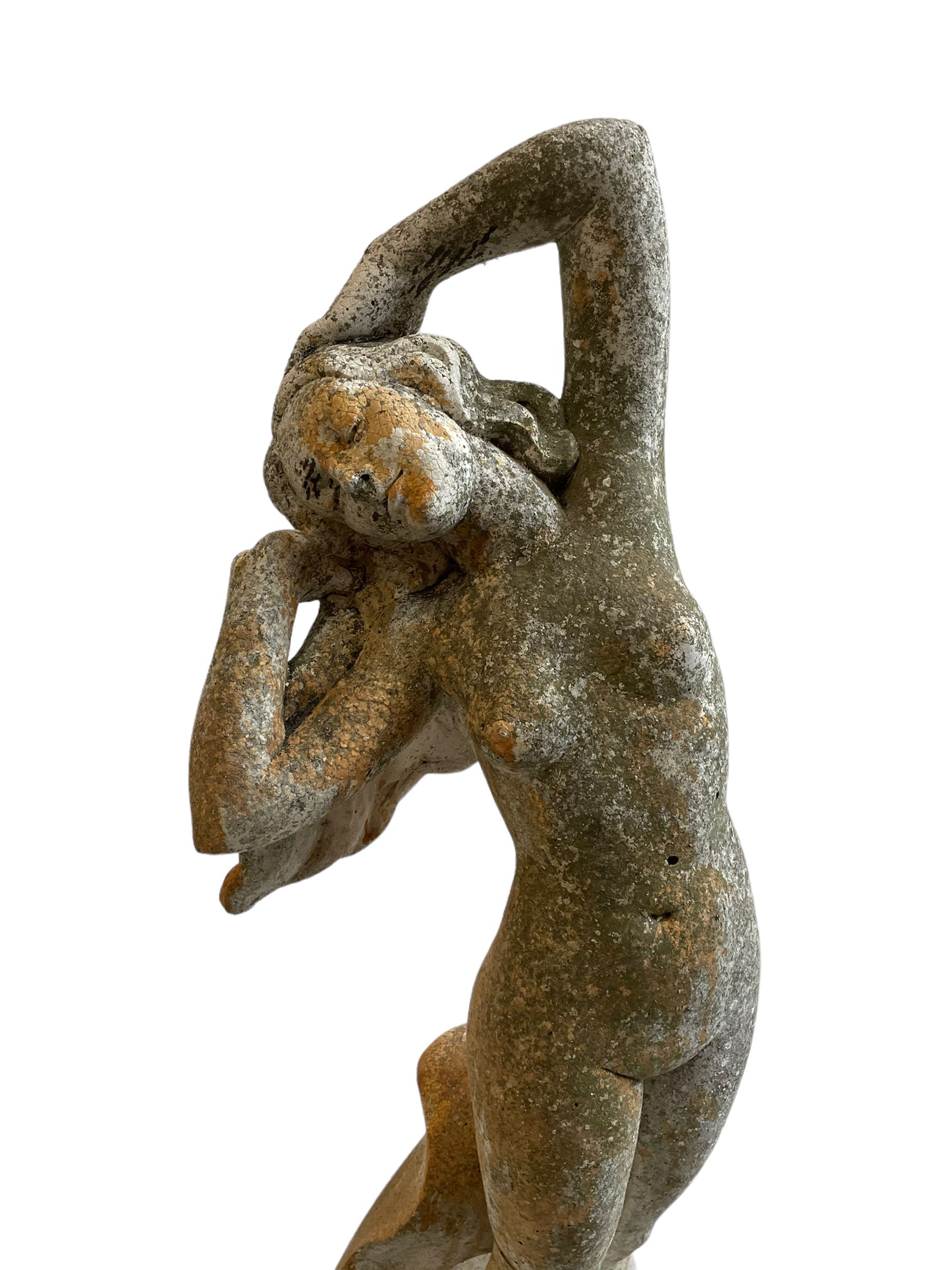 Cast stone two-piece garden figure of the Birth of Venus, depicting the goddess emerging from a stylised shell, on square base with stepped moulded plinth 