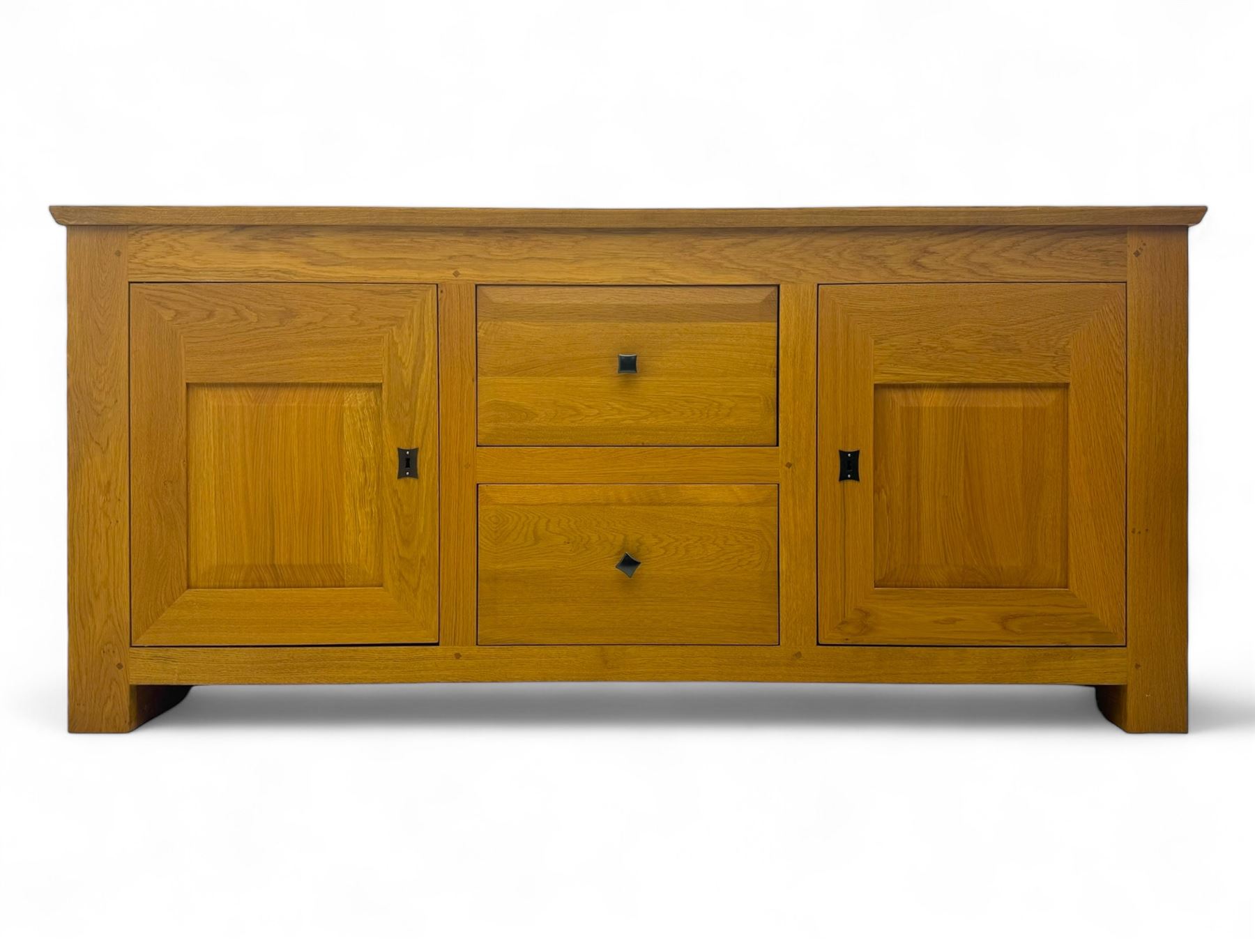 Contemporary light oak sideboard, chamfered rectangular top over two central bevel-edged drawers, flanked by two recessed panelled cupboards enclosing shelving, on square stile supports
