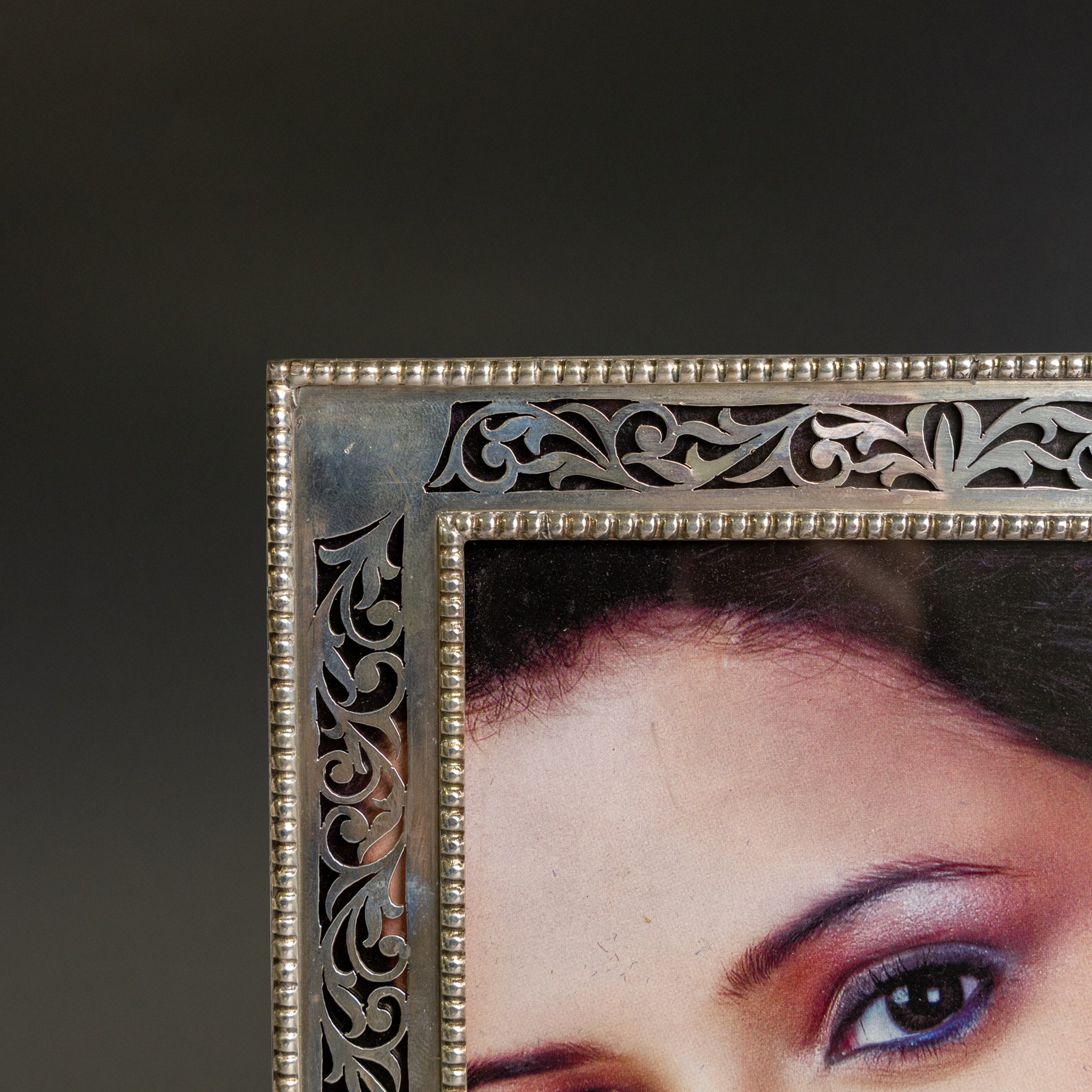 Indian silver folding double photograph frame, of rectangular form, with beaded border and pierced decoration, H22cm