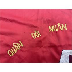 1960s North Vietnam banner embroidered in yellow thread on a red ground, roughly translates as 'Peoples Army of Viet Nam. Warriors of Viet Nam Determined To Keep The Country 1964' around a central military crest with the motto 'Warriors Keep The Country'; tassels to three sides 70 x 100cm