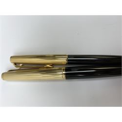 A Montblanc 227 fountain pen and 287 ballpoint pen set, circa 1970, each with black resin body, reeded gold plated cap, and white star emblem detail, the fountain pen with piston filling mechanism and nib marked 585, the ballpoint with lever action, in maker's case. 
