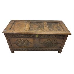 18th century oak blanket chest or coffer, rectangular hinged top with three panels and moulded edge, frieze carved with lunette and acanthus leaf decoration, two front panels carved with scrolling motif, raised on stile supports