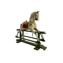 Attributed to F. H. Ayres - early 20th century carved wooden dapple grey rocking horse, with leather saddle and tack, with glass eyes, on green painted trestle base with turned column supports