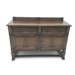  Early 20th century oak sideboard, raised shaped back, two drawers with blind fret work above two cupboard doors, cup and cover supports on shaped sledge feet joined by stretchers, W153 cm, H109cm, D60cm  