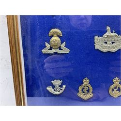 Twenty-eight glengarry and cap badges including Gordon Highlanders, Black Watch, Cameron, Lancashire Fusiliers, East Surrey, Gloucestershire, Welsh Guards, RAMC, Royal Artillery, Signal Corps, The Welch, RAF, Royal Engineers, York & Lancaster, US Army Officers Eagle etc; mounted and framed for display