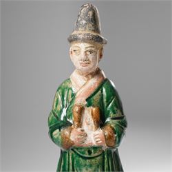 Pair of Chinese terracotta court attendant tomb figures,  probably Ming Dynasty, in Sancai green glaze, upon stepped square bases, H22cm 