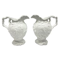 Pair of early/mid 19th century Copeland and Garrett white glazed pitchers, modelled in the Georgian style and moulded with the figures of Venus the Roman Goddess of Love, and Aurora the Roman Goddess of Dawn, within C scroll borders and foliate surround, the naturalistically modelled handle leading to a fruiting vine beneath the rim, upon a spreading base moulded with seashells, with printed green crowned wreath mark beneath, H20cm