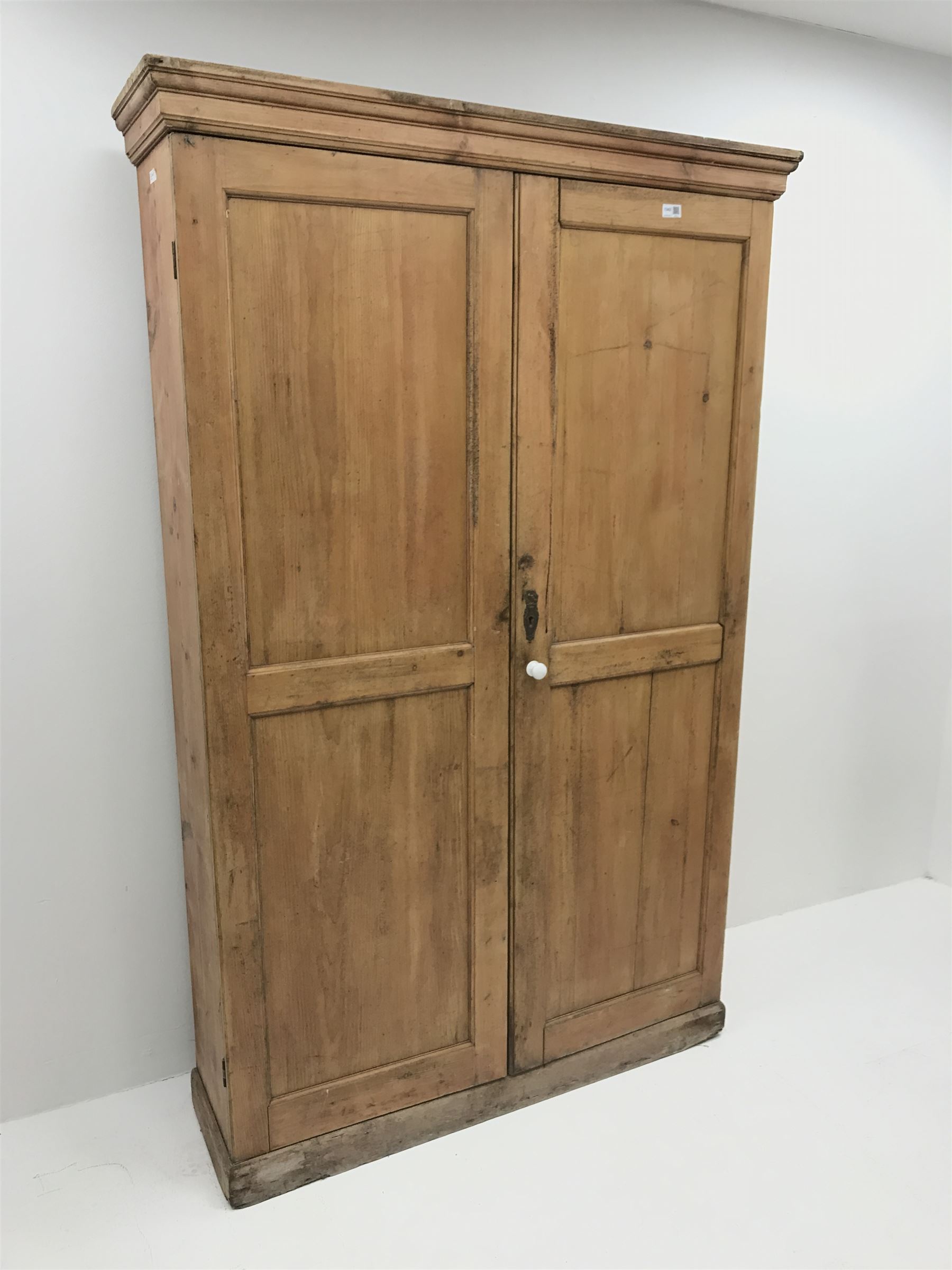 19th century housekeeping cupboard, projecting cornice above two panelled doors, plinth base